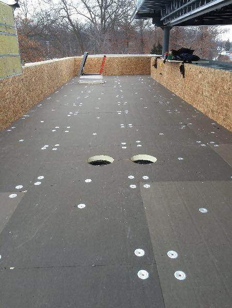 Flat Roof actively under construction with ladder leading up out of skylight hatch