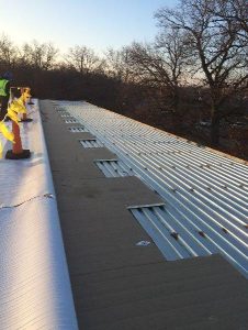 Edge of roof under construction cones and caution tape blocking off construction zone