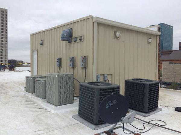 small room allowing roof access with corrugated sheet metal downspouts on corner
