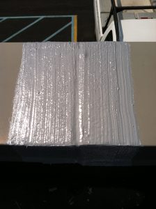 Example of roof sealant on a board ass a demonstration