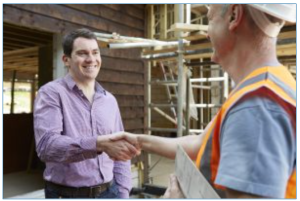 Construction worker shaking hand with client